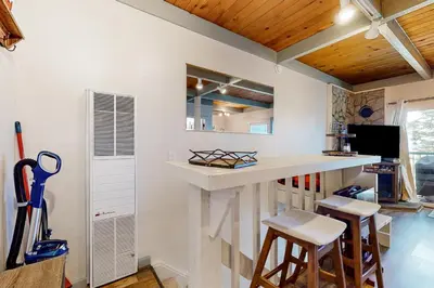 a kitchen with a white counter and stools at Tahoe Heavenly Hideaway in Stateline