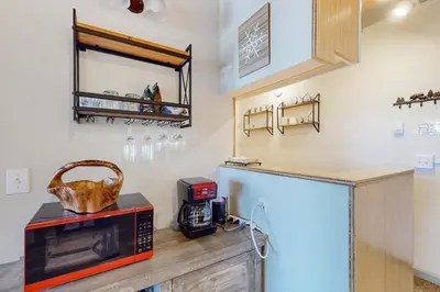 a kitchen with a microwave on top of a counter at Tahoe Heavenly Hideaway in Stateline