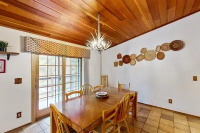 a dining room with a table and wooden ceilings at Scenes of Evergreens in Incline Village