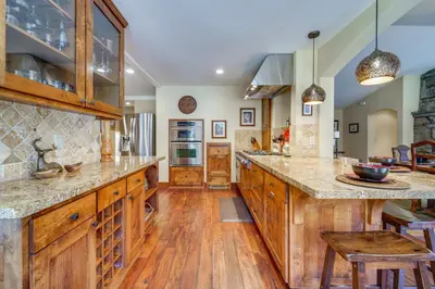 a large kitchen with wooden cabinets and wooden floors at Private Patio and Gas Grill Stunning Truckee Home in Truckee