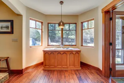 an empty living room with windows and a wooden floor at Private Patio and Gas Grill Stunning Truckee Home in Truckee