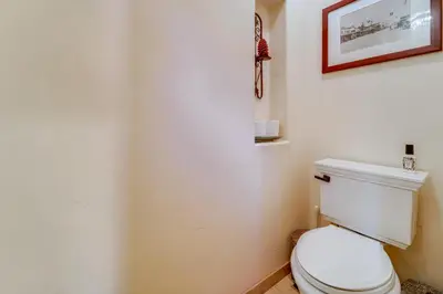 a bathroom with a toilet and a picture on the wall at Private Patio and Gas Grill Stunning Truckee Home in Truckee