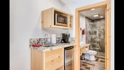 a small bathroom with a sink and a toilet at #2 Cottage Like Suite With Private Hot Tub in Bass Lake