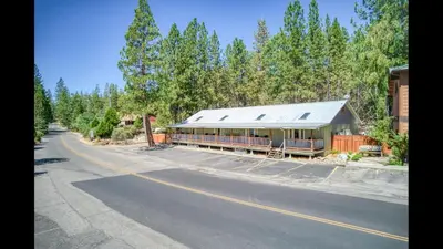 a building sitting on the side of a road at #2 Cottage Like Suite With Private Hot Tub in Bass Lake