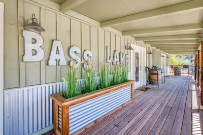 a porch with a large sign on the side of a house at #3 Cottage Like Suite With Private Hot Tub in Bass Lake