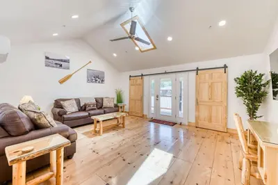 a living room with a couch and a table at #3 Cottage Like Suite With Private Hot Tub in Bass Lake