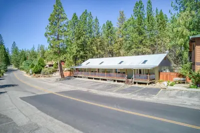 a building on the side of a road next to a street at #3 Cottage Like Suite With Private Hot Tub in Bass Lake