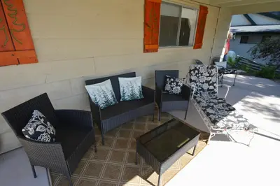 a patio with two chairs and a table with pillows at Fox Lake View in Bass Lake