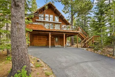 a log home with a deck and a driveway at Incline Village Getaway in Incline Village