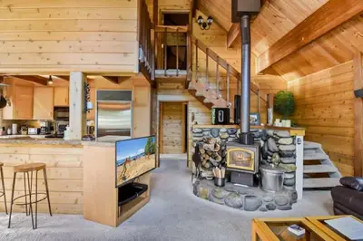 a living room with a fireplace in a log cabin at Incline Village Getaway in Incline Village