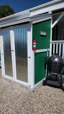 a green garage with a grill next to it at Mystic Mountain Retreat in Miramonte