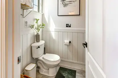 a bathroom with a toilet with a vase on top of it at Enchanting Clovis Haven with Hot Tub and Private Pool! in Clovis