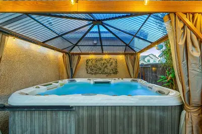 a hot tub in a greenhouse with a roof at Enchanting Clovis Haven with Hot Tub and Private Pool! in Clovis
