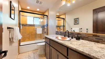 a bathroom with a sink and a shower at 10mins to Lake • Hot Tub Game Room Forest Views Meyers Meadow by AvantStay in South Lake Tahoe