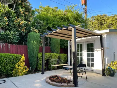 a pergola with a table and a chair under it at Cozy Suite with Private Patio Close to Downtown and UC Davis Medical Center in Sacramento