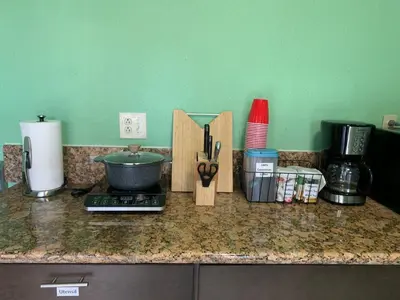 a kitchen counter with a counter top with utensils at Cozy Suite with Private Patio Close to Downtown and UC Davis Medical Center in Sacramento
