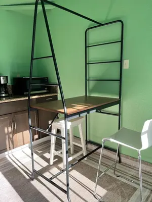a desk and a chair in a room with a green wall at Cozy Suite with Private Patio Close to Downtown and UC Davis Medical Center in Sacramento