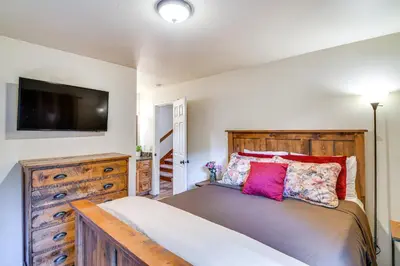 a bedroom with a bed and a flat screen tv at 1 Mi to Ski Resort South Lake Tahoe Townhome in South Lake Tahoe
