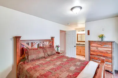 a bedroom with a large bed with a wooden headboard at 1 Mi to Ski Resort South Lake Tahoe Townhome in South Lake Tahoe
