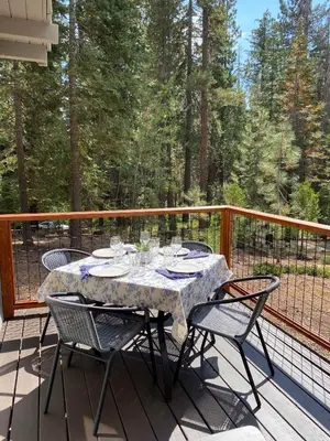 a table with wine glasses on a deck at 3BD Retreat - 5 Min to Beach Trails & Town in Carnelian Bay