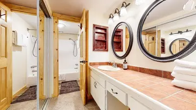 a bathroom with a sink and a mirror at Sierra Park Road #150 condo in Mammoth Lakes