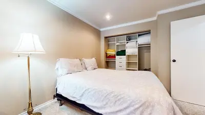 a bedroom with a bed and a lamp and an open closet at Lakeview Villas #27 condo in Mammoth Lakes
