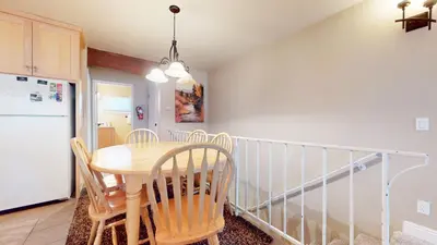 a kitchen with a table and chairs and a refrigerator at Lakeview Villas #27 condo in Mammoth Lakes