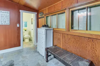 a bathroom with a bench and a toilet at 8 Mi to Yosemite National Park Cabin with Fire Pit in Oakhurst