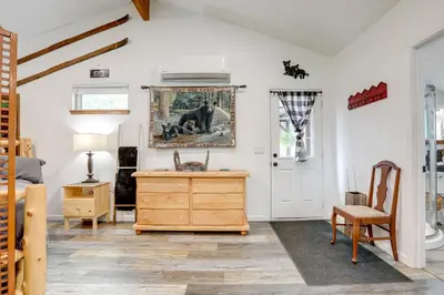 a room with a dresser and a painting on the wall at Cozy Cottage with Park Pass, 1 Mi to Jenkinson Lake! in Pollock Pines