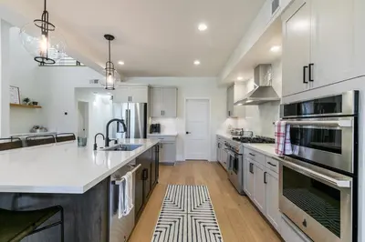 a kitchen with white cabinets and a large white counter top at Crestwood at Schaffer's Mill in Truckee