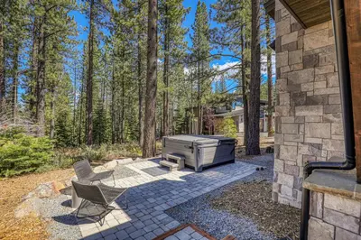 a backyard patio with a grill and chairs at Crestwood at Schaffer's Mill in Truckee