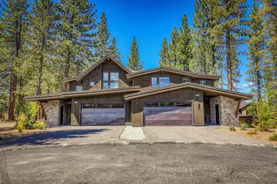 a large house with a garage in the woods at Crestwood at Schaffer's Mill in Truckee