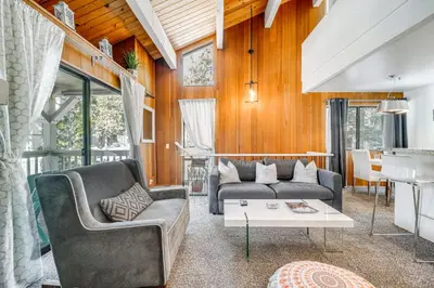 a living room with two couches and a table at 1 Mi to Lake Tahoe Condo with Pool Access in Kings Beach
