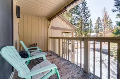 a porch with two chairs and a table at 1 Mi to Lake Tahoe Condo with Pool Access in Kings Beach