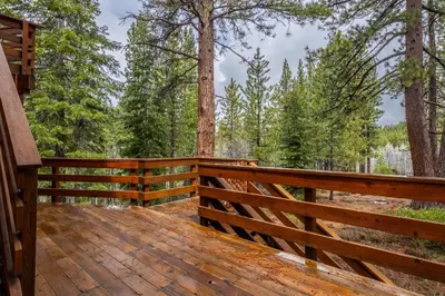 a wooden deck with a fence and trees at Northstar - Northstar Vista in Truckee