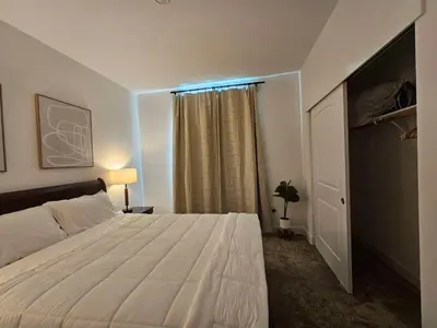 a bedroom with a white bed and a window at Couple's Getaway Kitchenette Washer & Private Bath in Lincoln Village
