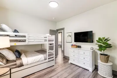 a bedroom with two bunk beds and a tv at Game Room and Patio Picturesque Home in Sonora in Sonora