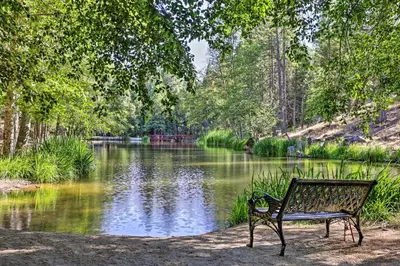 a park bench sitting in front of a lake at Game Room and Patio Picturesque Home in Sonora in Sonora