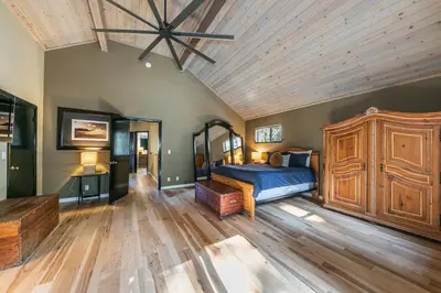 a bedroom with a large bed and a wooden ceiling at Raven Retreat at Tahoe Donner - 3 BR w Forest Views! in Truckee