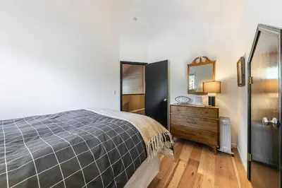 a bedroom with a bed and a dresser and a mirror at Raven Retreat at Tahoe Donner - 3 BR w Forest Views! in Truckee