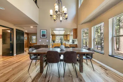 a dining room with a wooden table and chairs at Raven Retreat at Tahoe Donner - 3 BR w Forest Views! in Truckee