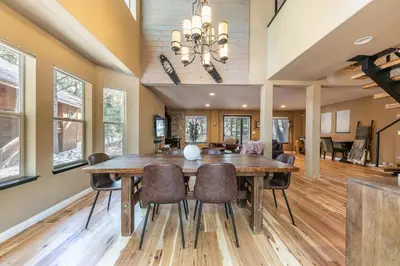 a dining room with a large wooden table and chairs at Raven Retreat at Tahoe Donner - 3 BR w Forest Views! in Truckee