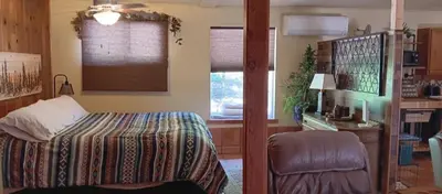 a bedroom with a bed and a desk and a window at 1948 Cottage with today's amenities in Bass Lake Annex