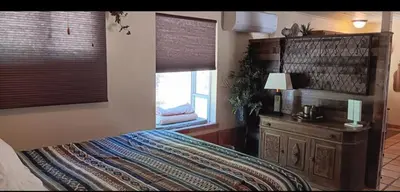 a bedroom with a large bed and a window at 1948 Cottage with today's amenities in Bass Lake Annex