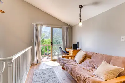 a living room with a couch and a window at Beautiful Kernville Home with Game Room and Mtn Views! in Kernville