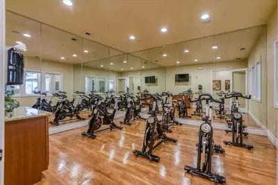a gym with a lot of treadmills and ellipticals at Relaxing 2-BR Apt with Pool Hot Tub Gym and Basketball Court Access in Reno