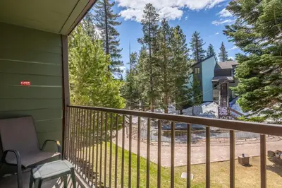a view from the balcony of a house with a chair at Fully Renovated! St Anton #17 Ski in Ski Out 1 Bedroom 1 Bathroom Condo! Sleeps up to 4! in Mammoth Lakes