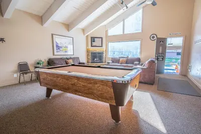 a living room with a pool table in it at Fully Renovated! St Anton #17 Ski in Ski Out 1 Bedroom 1 Bathroom Condo! Sleeps up to 4! in Mammoth Lakes