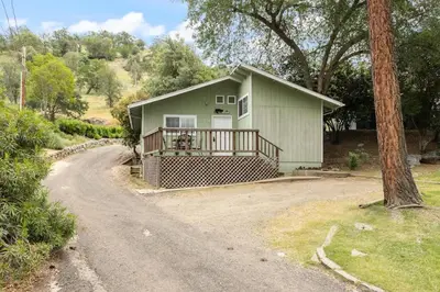 a small house with a porch and a driveway at The General Sherman Cabin in Three Rivers