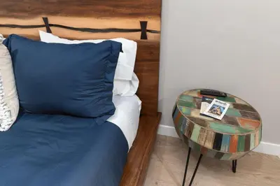 a bedroom with a bed with a table next to it at The General Sherman Cabin in Three Rivers